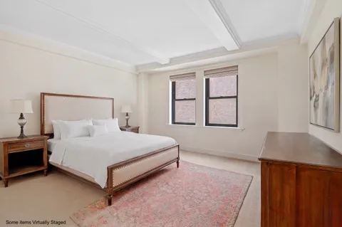 a spacious bedroom with a bed and a window