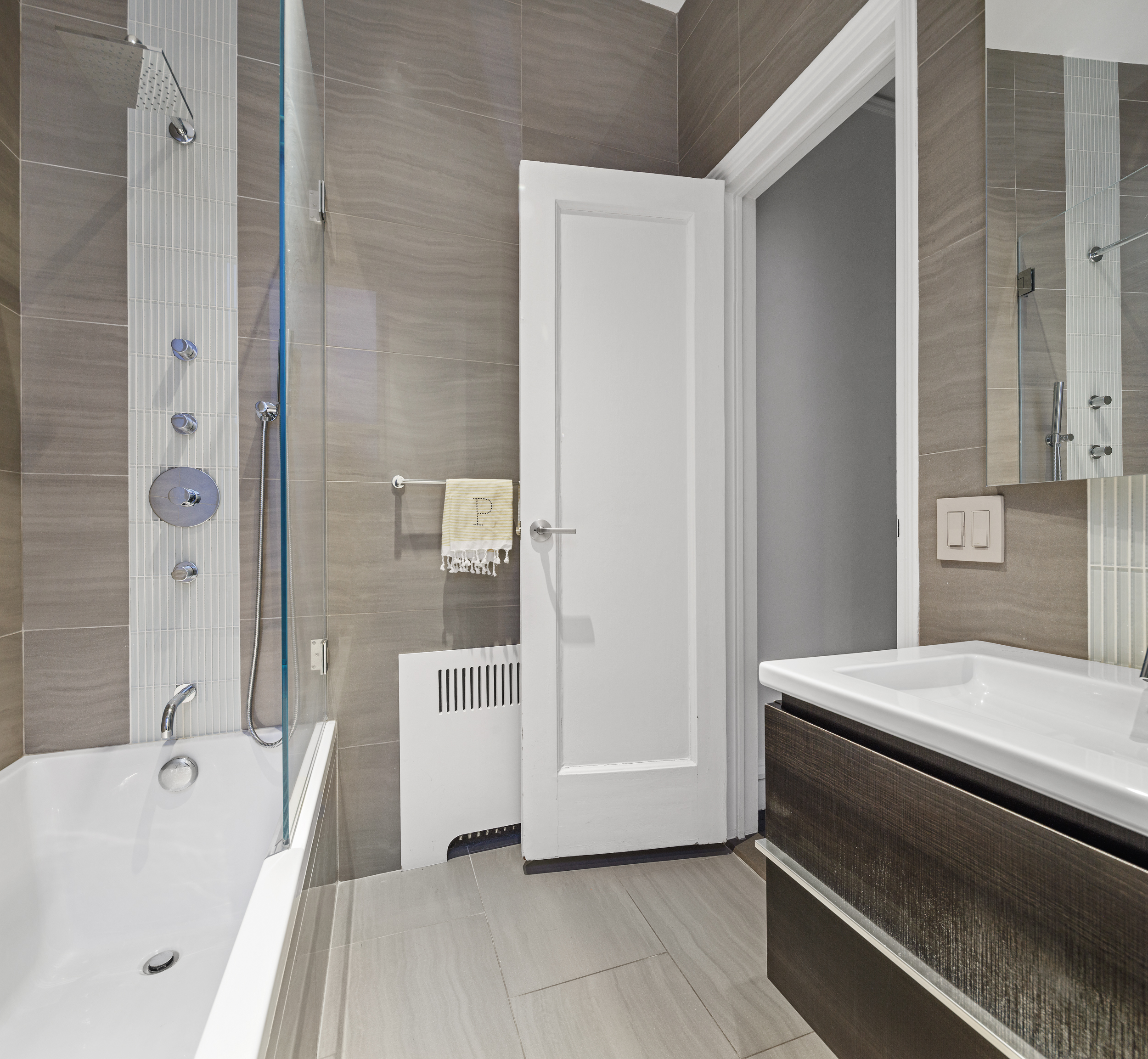 180 West 58th Street, Unit 11A Manhattan, NY 10019 - Photo 14 of 17 a bathroom with a bathtub and a shower