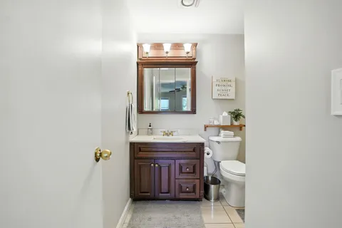a bathroom with a toilet a sink and mirror