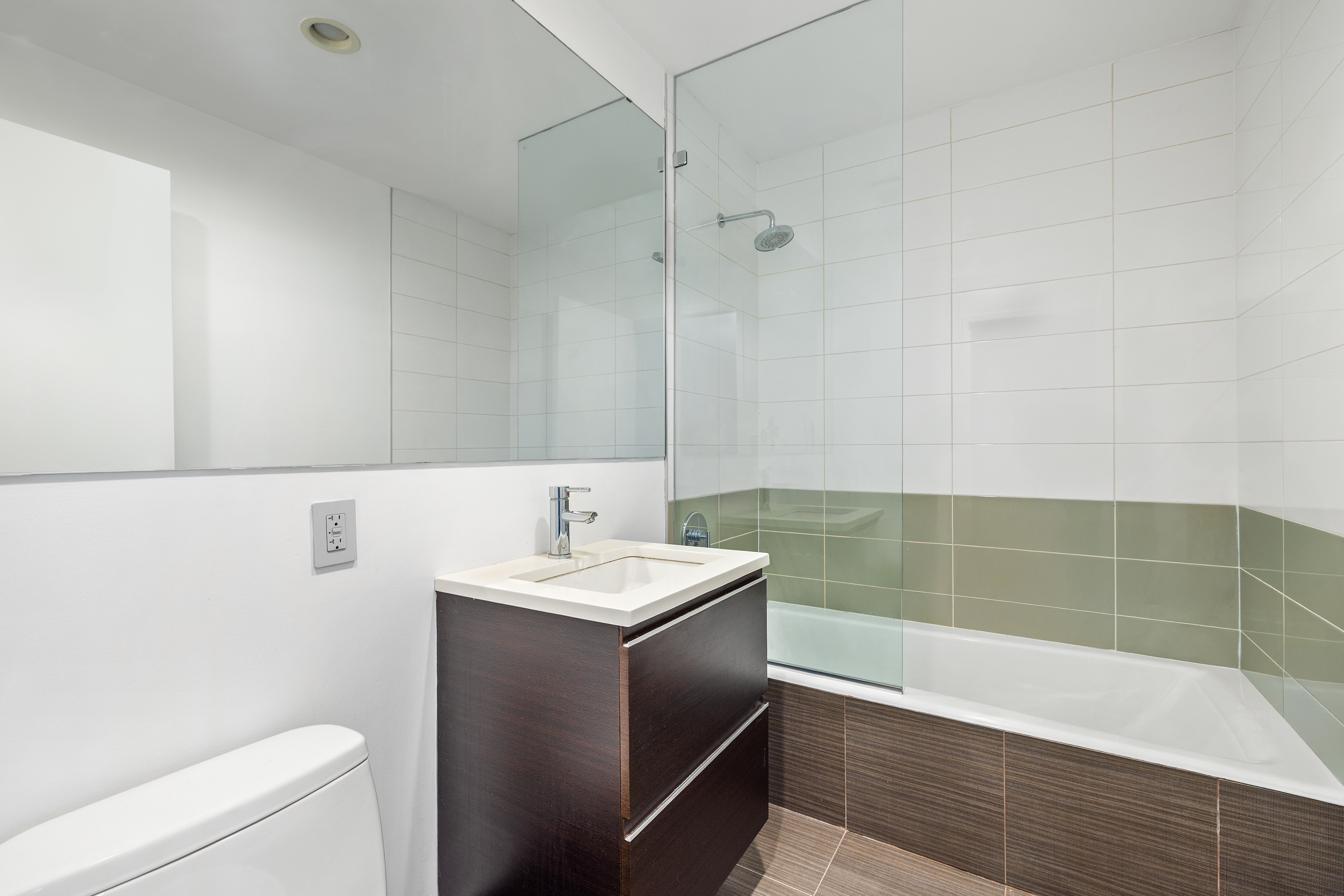 2-26 50th Avenue, Unit 10F Queens, NY 11101 - Photo 8 of 11 a bathroom with a sink a toilet and shower