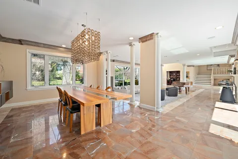 a living room with furniture a flat screen tv and a large window