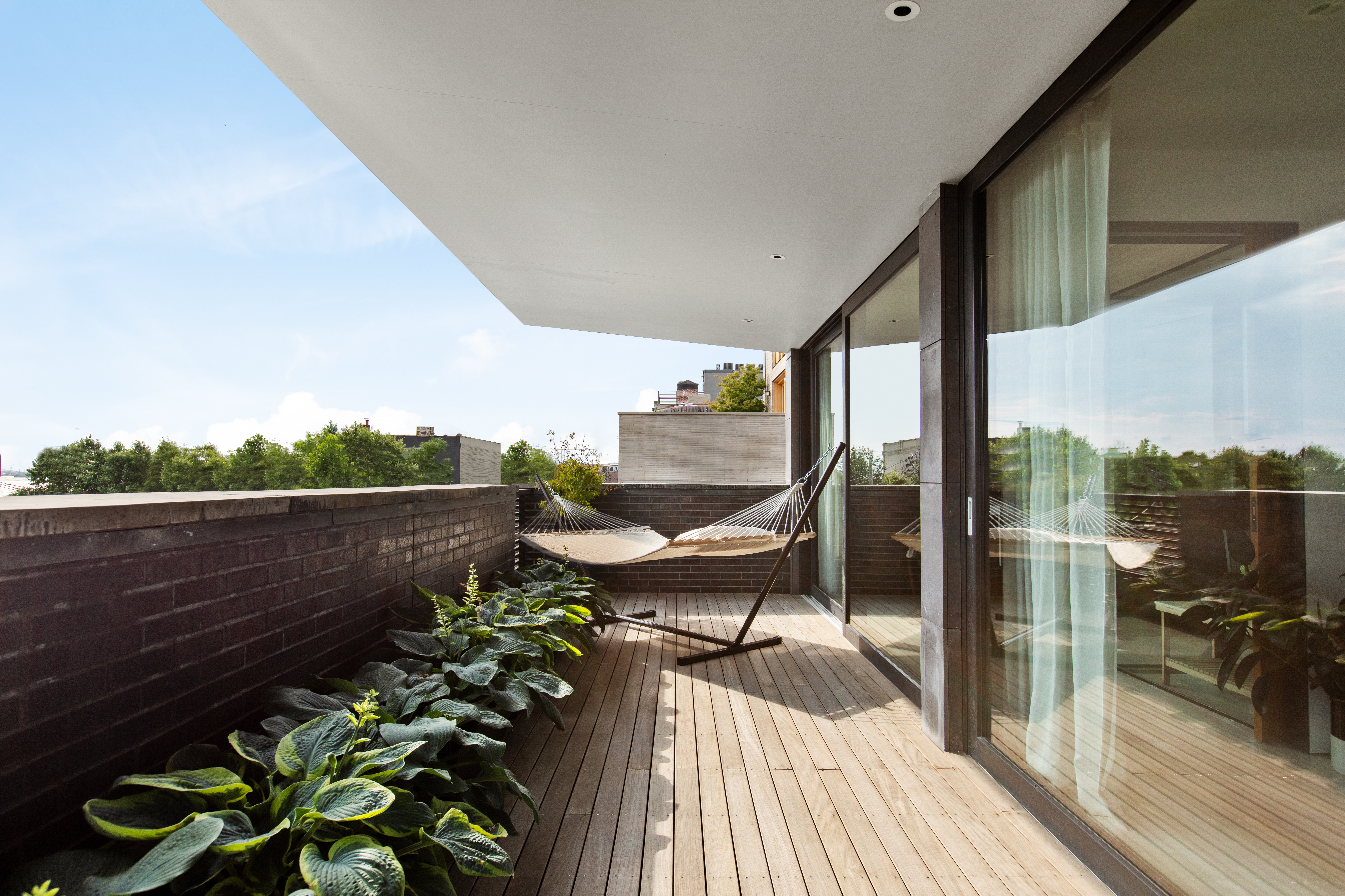 440 Van Brunt Street Brooklyn, NY 11231 - Photo 30 of 33 a view of a balcony with chairs and wooden floor