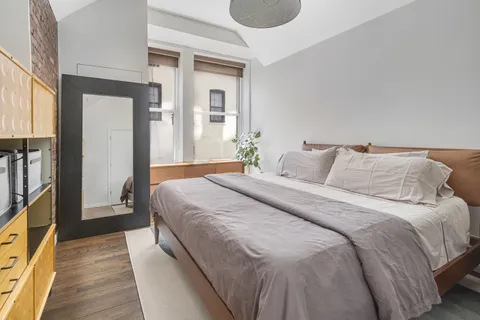 a bedroom with double bed and a window