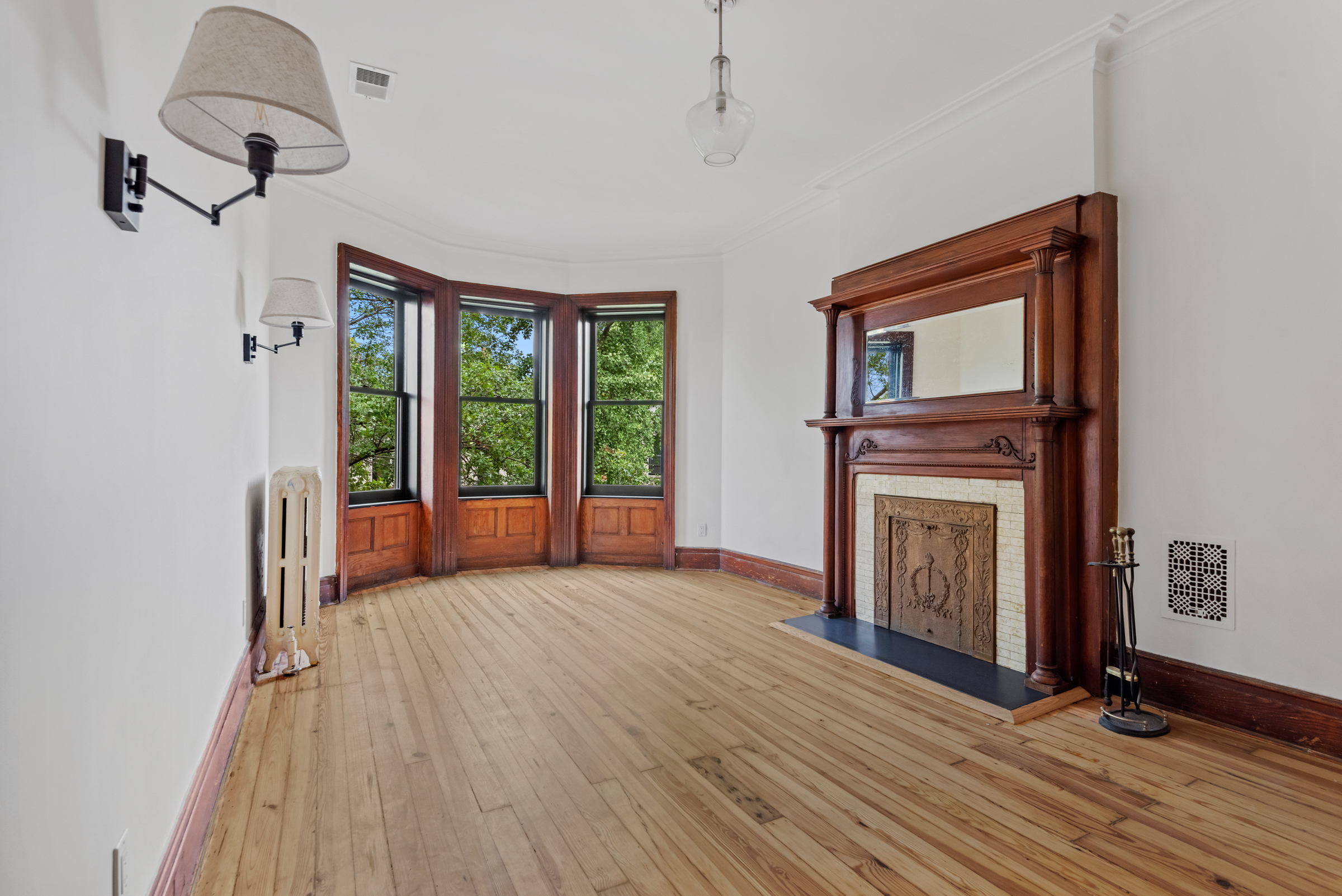 616 2nd Street Brooklyn, NY 11215 - Photo 16 of 19 a view of a livingroom with wooden floor and a fireplace