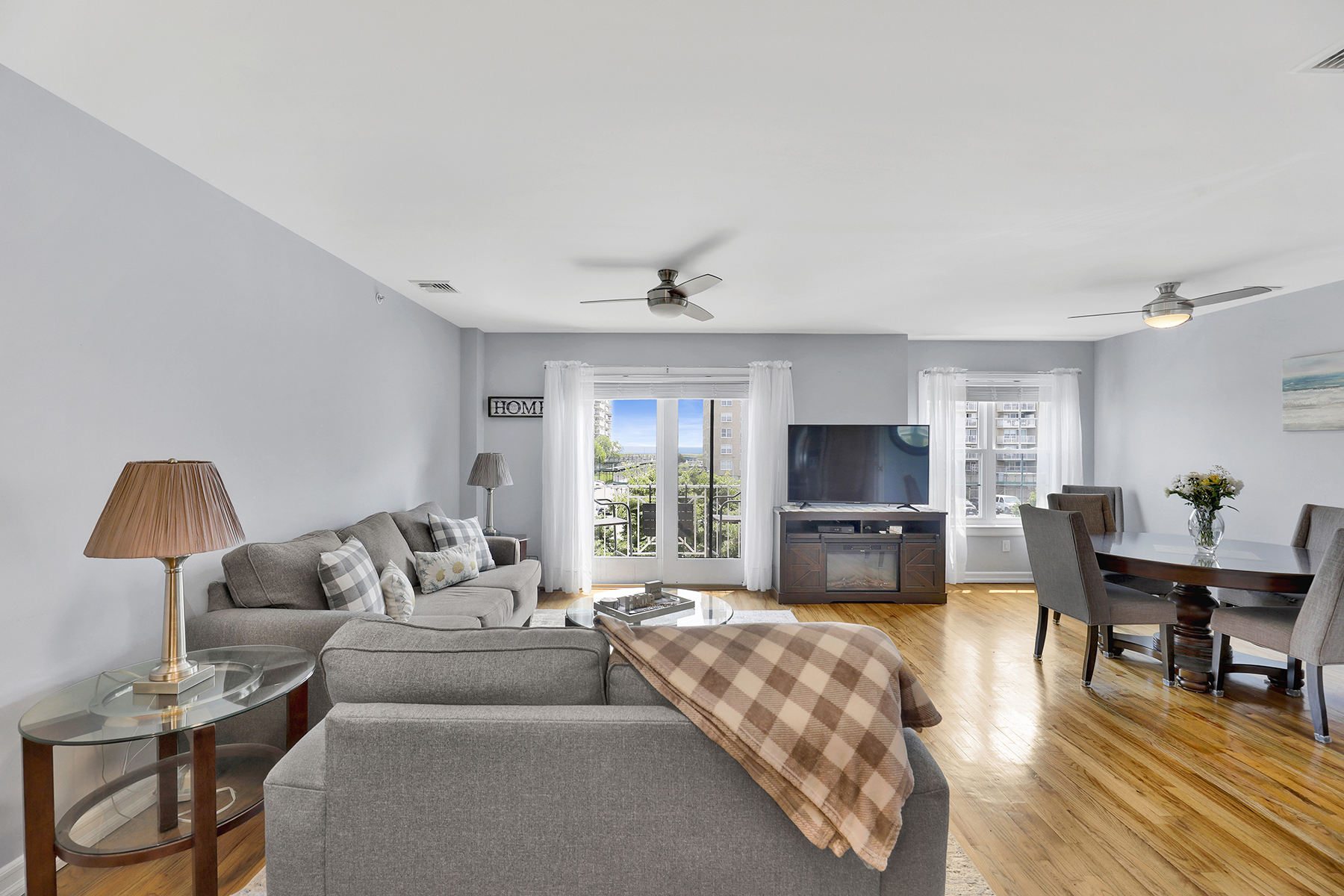 10220 Rockaway Beach Boulevard, Unit 3C Queens, NY 11694 - Photo 24 of 46 a living room with furniture and a flat screen tv