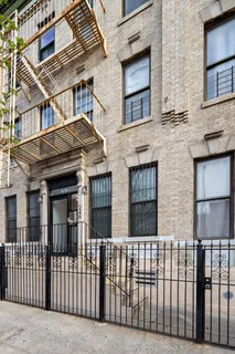 a view of a brick house many windows