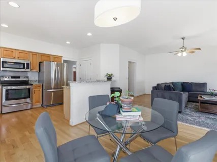 a kitchen with stainless steel appliances granite countertop white cabinets granite counter tops and a window