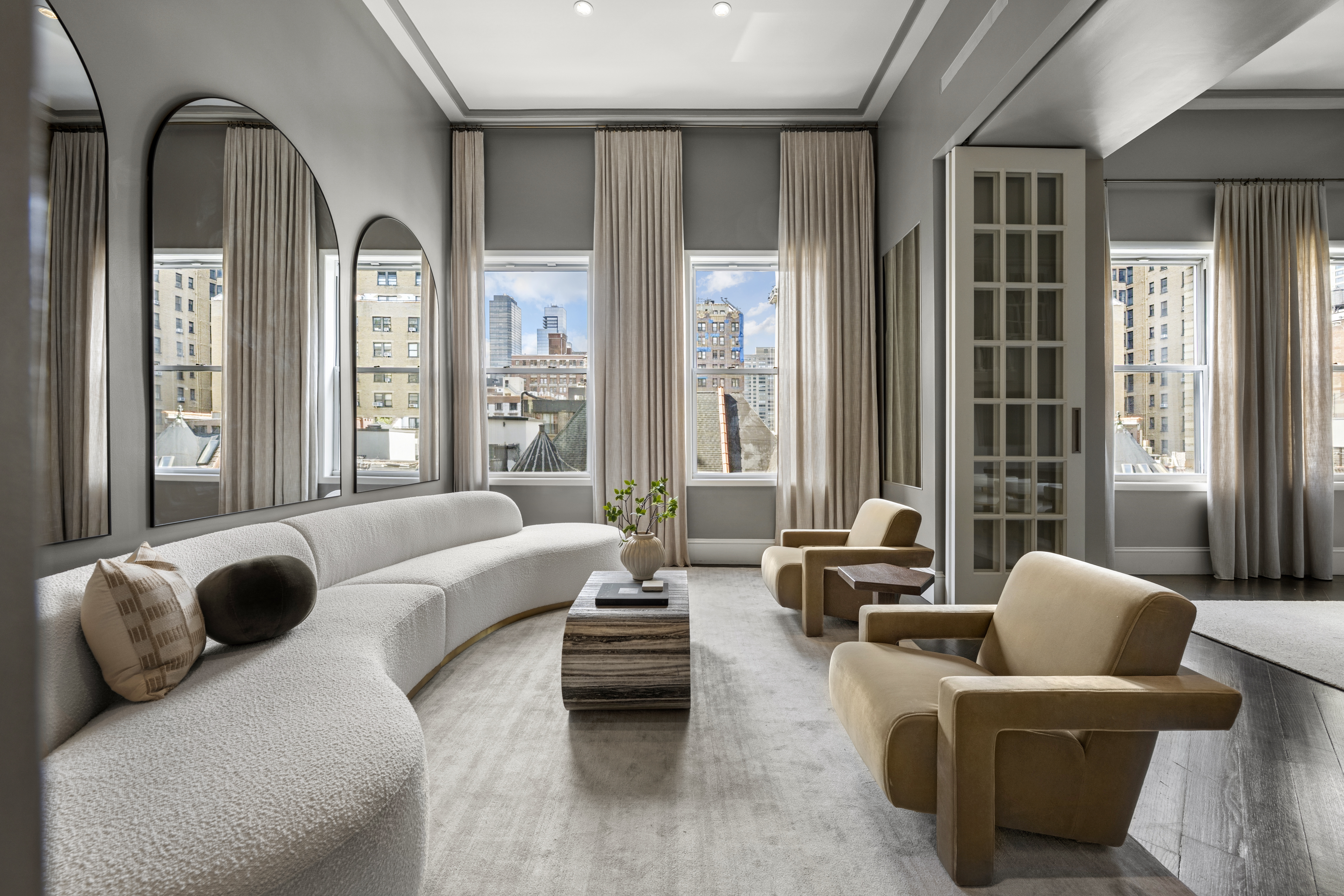 253 West 73rd Street, Unit 6B-C Manhattan, NY 10023 - Photo 2 of 21 a living room with furniture and floor to ceiling windows