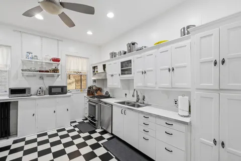a kitchen with cabinets and window