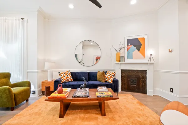 a living room with furniture a fireplace and a window
