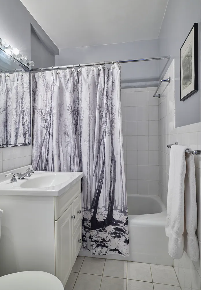 a bathroom with a granite countertop sink a toilet and a shower