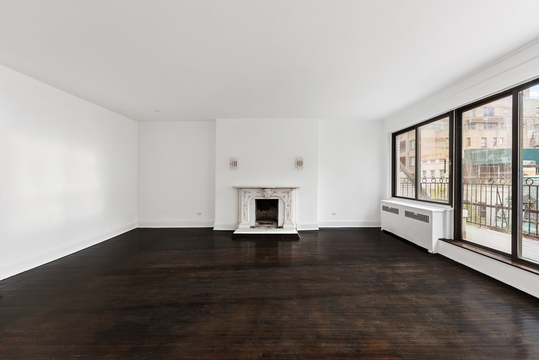 7 East 74th Street, Unit PH Manhattan, NY 10021 - Photo 2 of 10 a view of empty room with wooden floor and fireplace