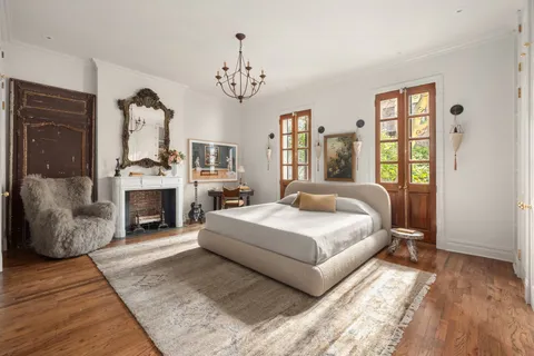 a spacious bedroom with a large bed and a fireplace