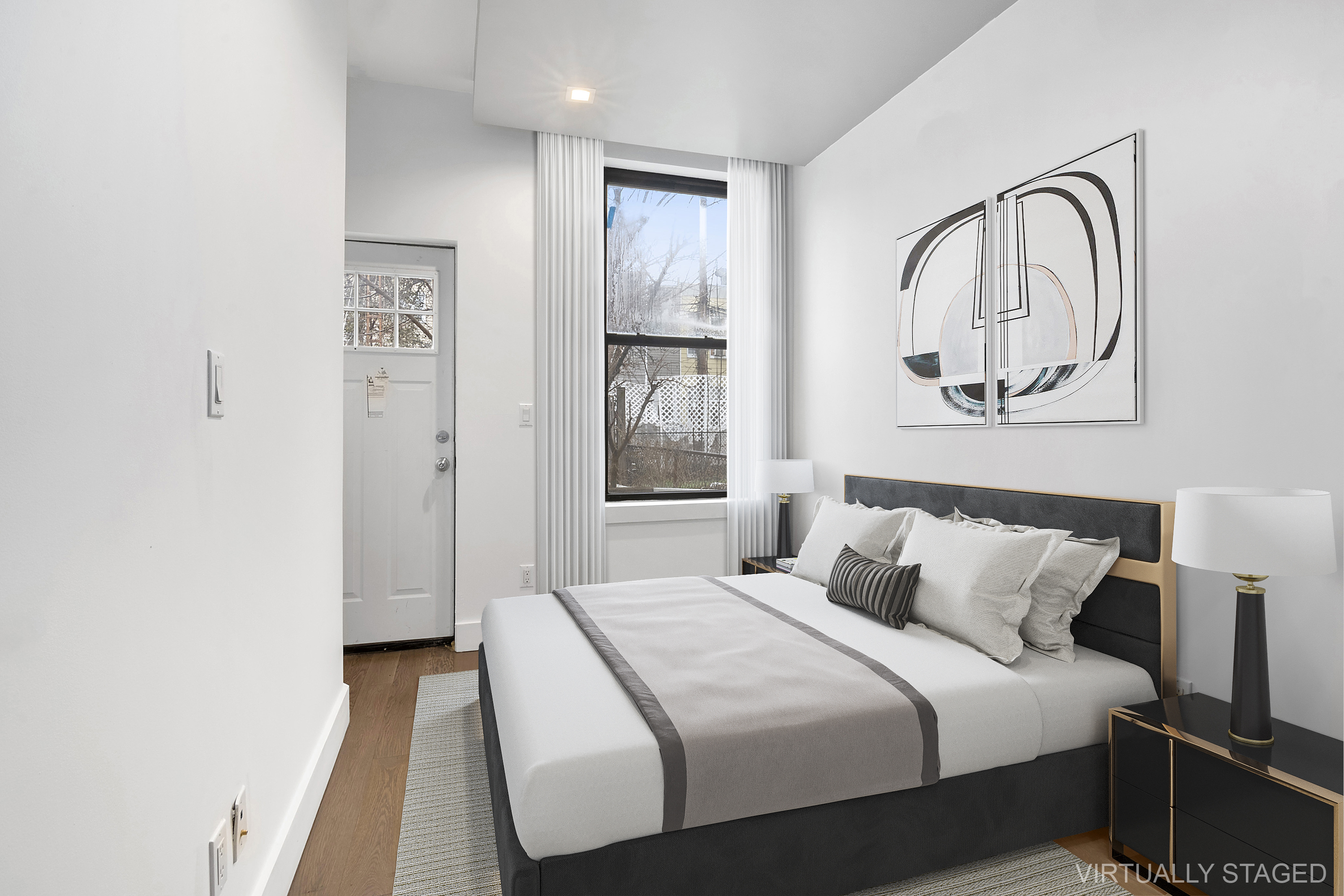 20-27 Menahan Street, Unit 1R Queens, NY 11385 - Photo 10 of 12 a bedroom with a bed and a window