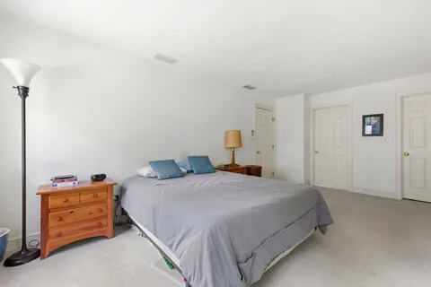 a bedroom with a bed and dresser