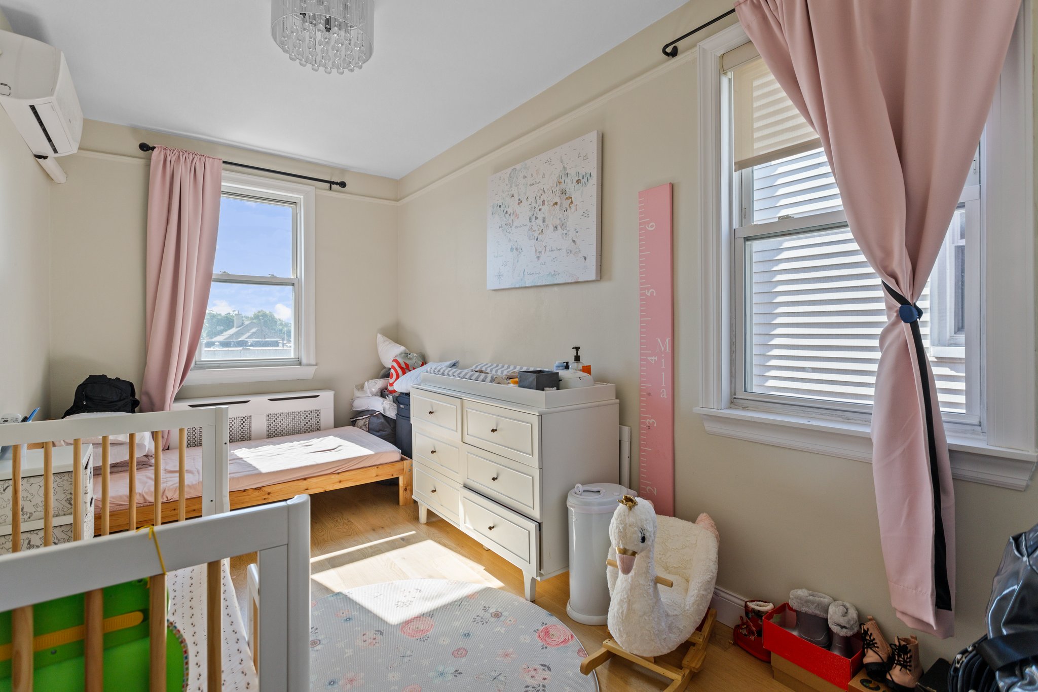 22-45 47th Street, Unit 3 Queens, NY 11105 - Photo 11 of 14 a bedroom with a baby bed baby crib and a window