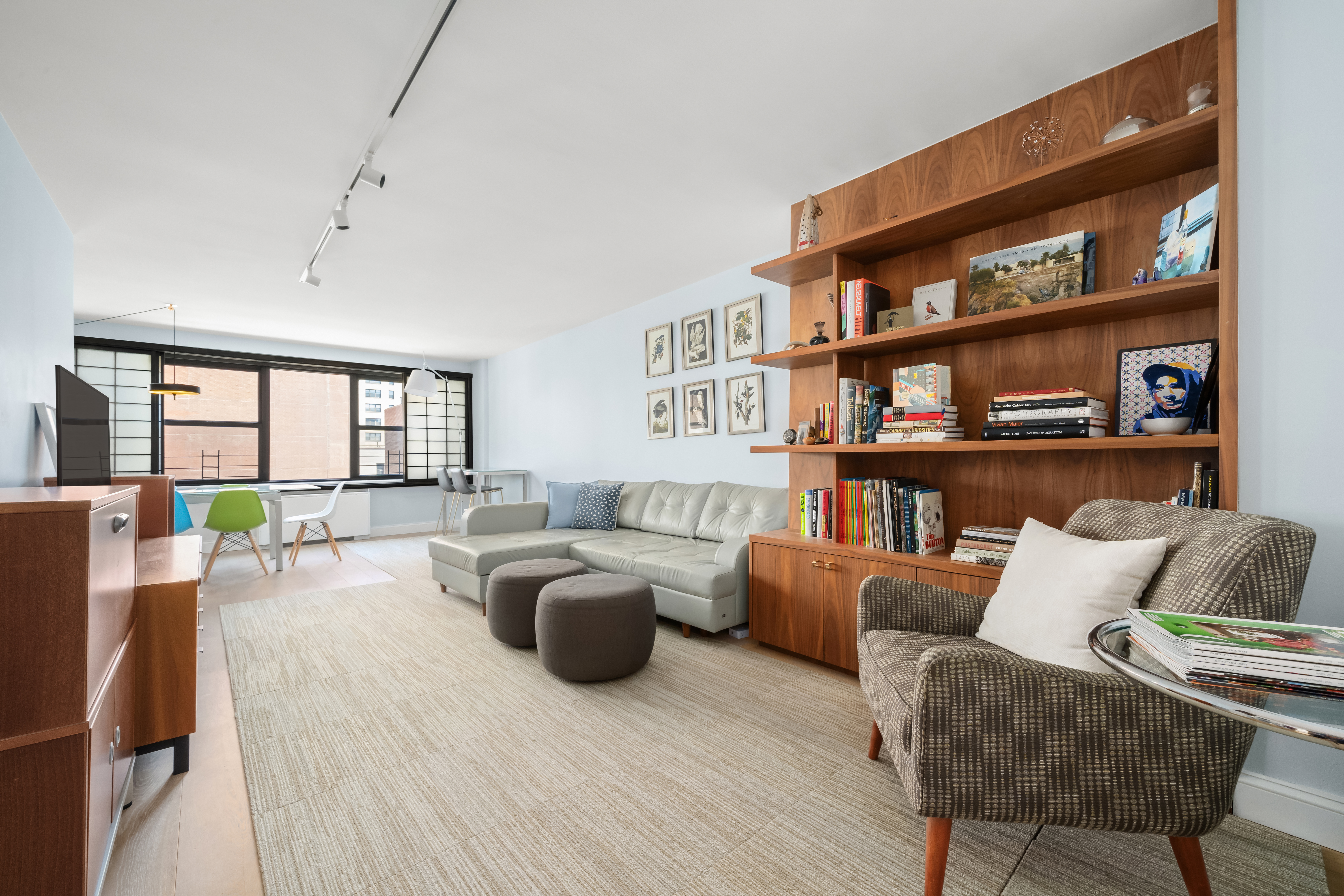 a living room with furniture and a book shelf