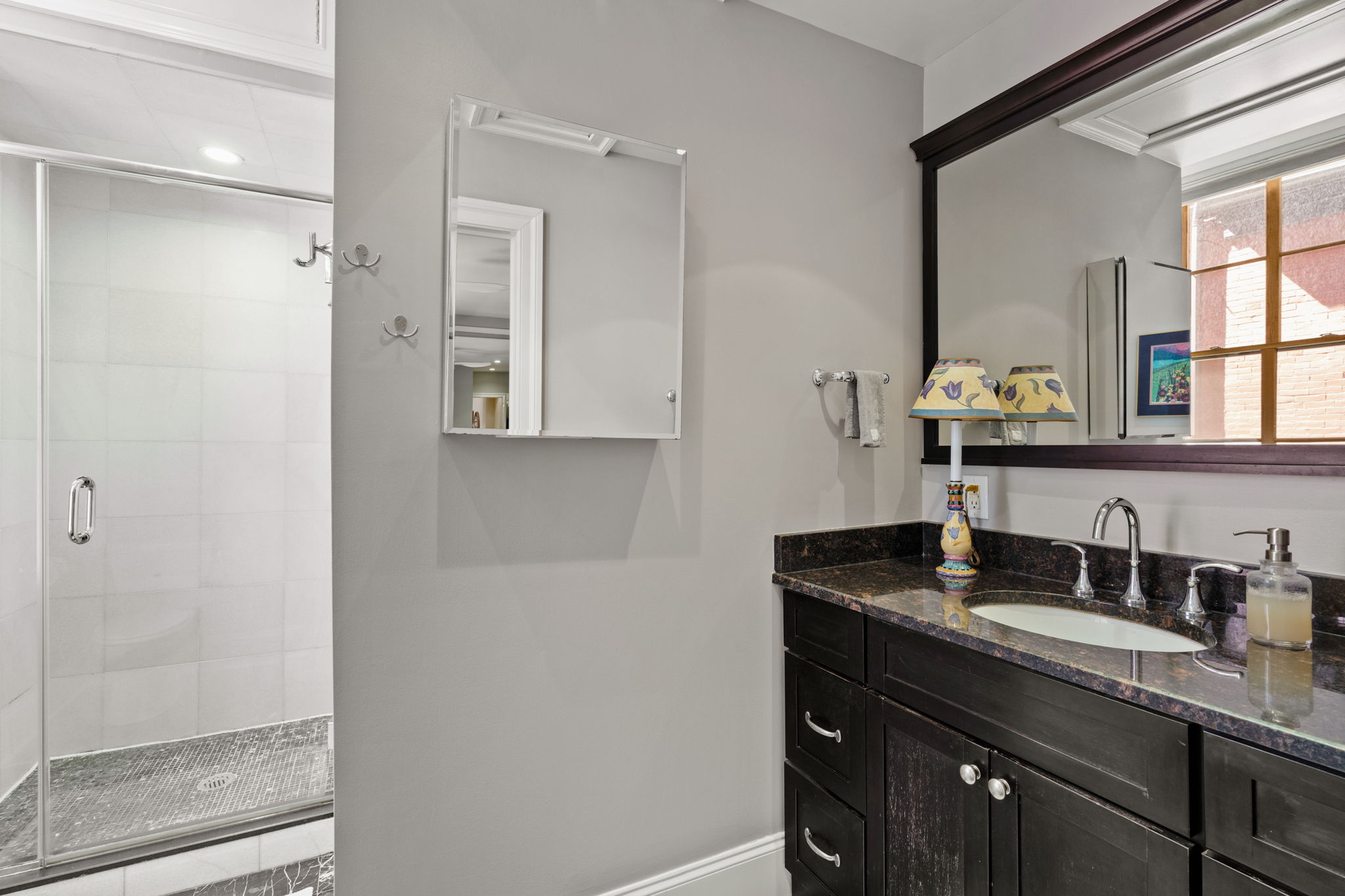 2049 Walnut Street, Unit 1R Philadelphia, PA 19103 - Photo 15 of 18 a bathroom with a granite countertop sink and a mirror