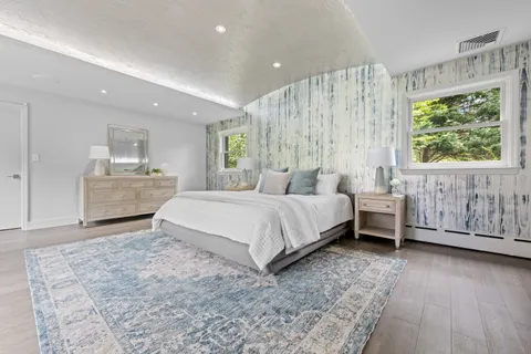 a bedroom with a large bed and a dresser