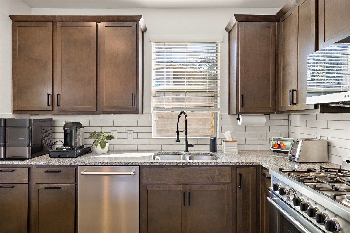 1402 Singleton Avenue, Unit B Austin, TX 78702 - Photo 6 of 26 a kitchen with stainless steel appliances granite countertop a sink stove and cabinets