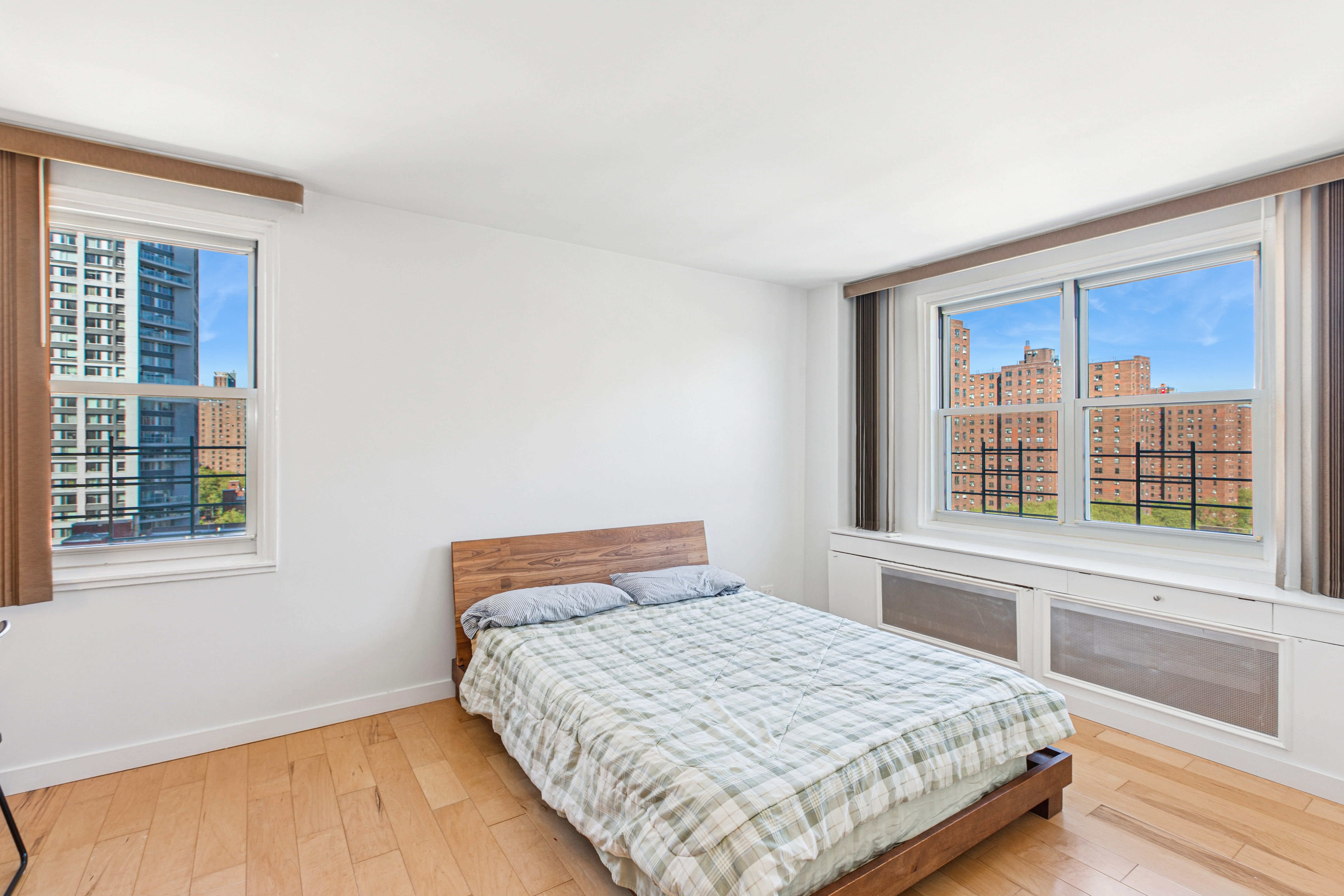 1270 5th Avenue, Unit 12C Manhattan, NY 10029 - Photo 7 of 18 a bedroom with a bed and a window