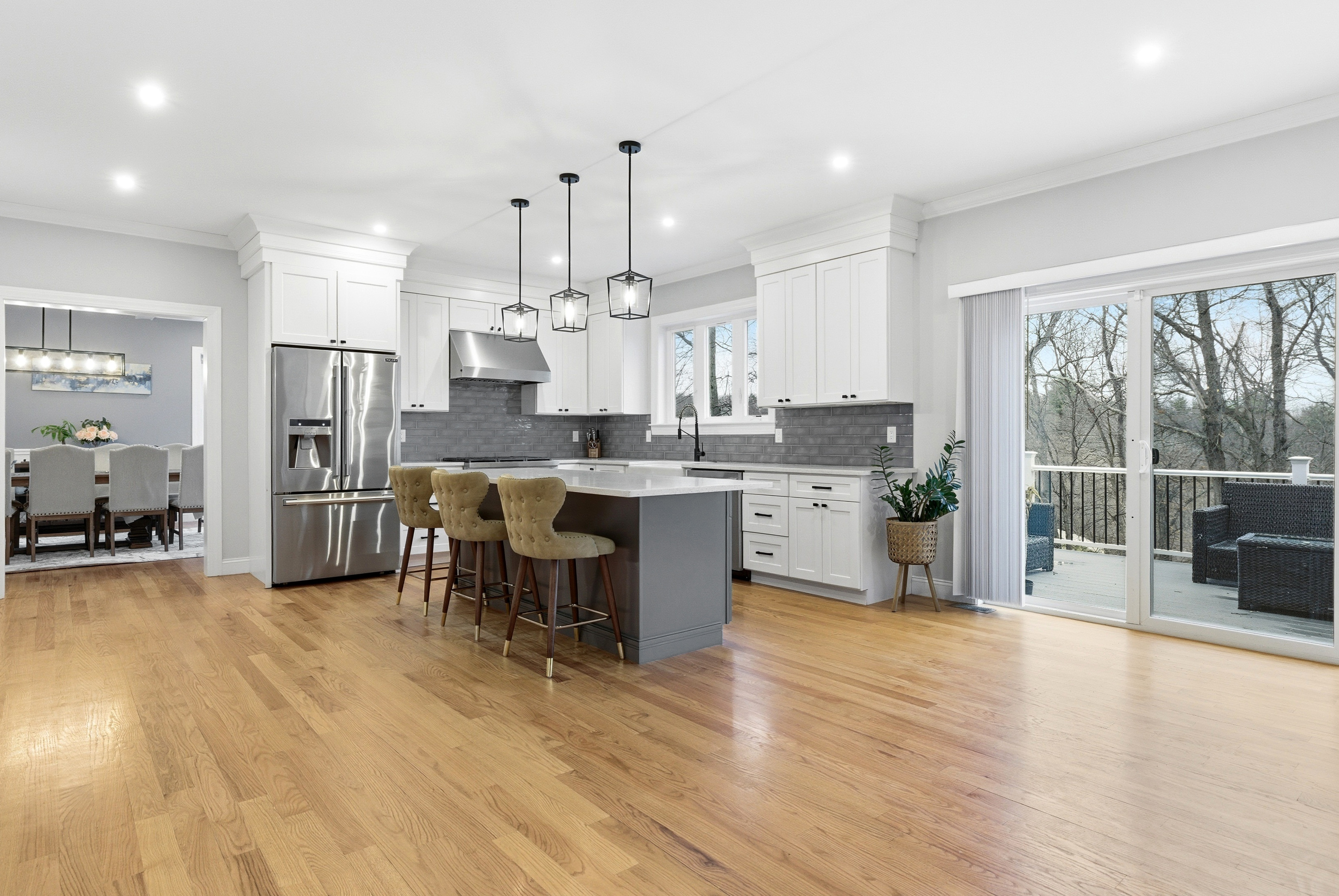 41 Peach Orchard Road Burlington, MA 01803 - Photo 2 of 15 a kitchen with stainless steel appliances kitchen island granite countertop a refrigerator a stove a sink a dining table and chairs with wooden floor