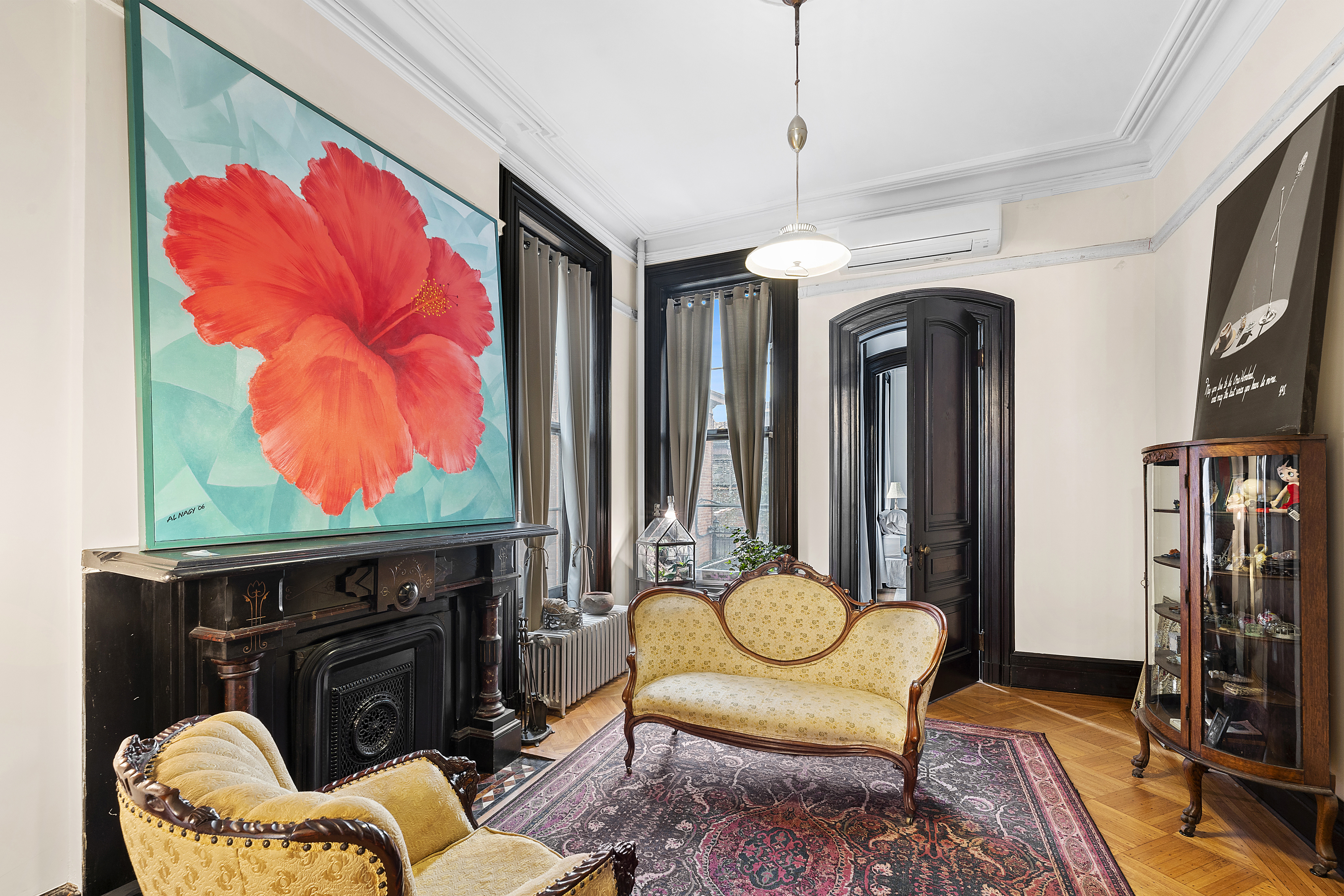 419 Clinton Avenue Brooklyn, NY 11238 - Photo 3 of 19 a living room with furniture a flat screen tv and a fireplace