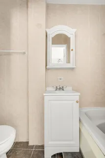 a bathroom with a sink a toilet and a mirror