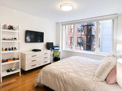 a bedroom with a bed and a flat screen tv