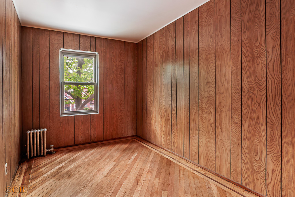 1221 Troy Avenue Brooklyn, NY 11203 - Photo 7 of 10 a view of a room with wooden walls and a window