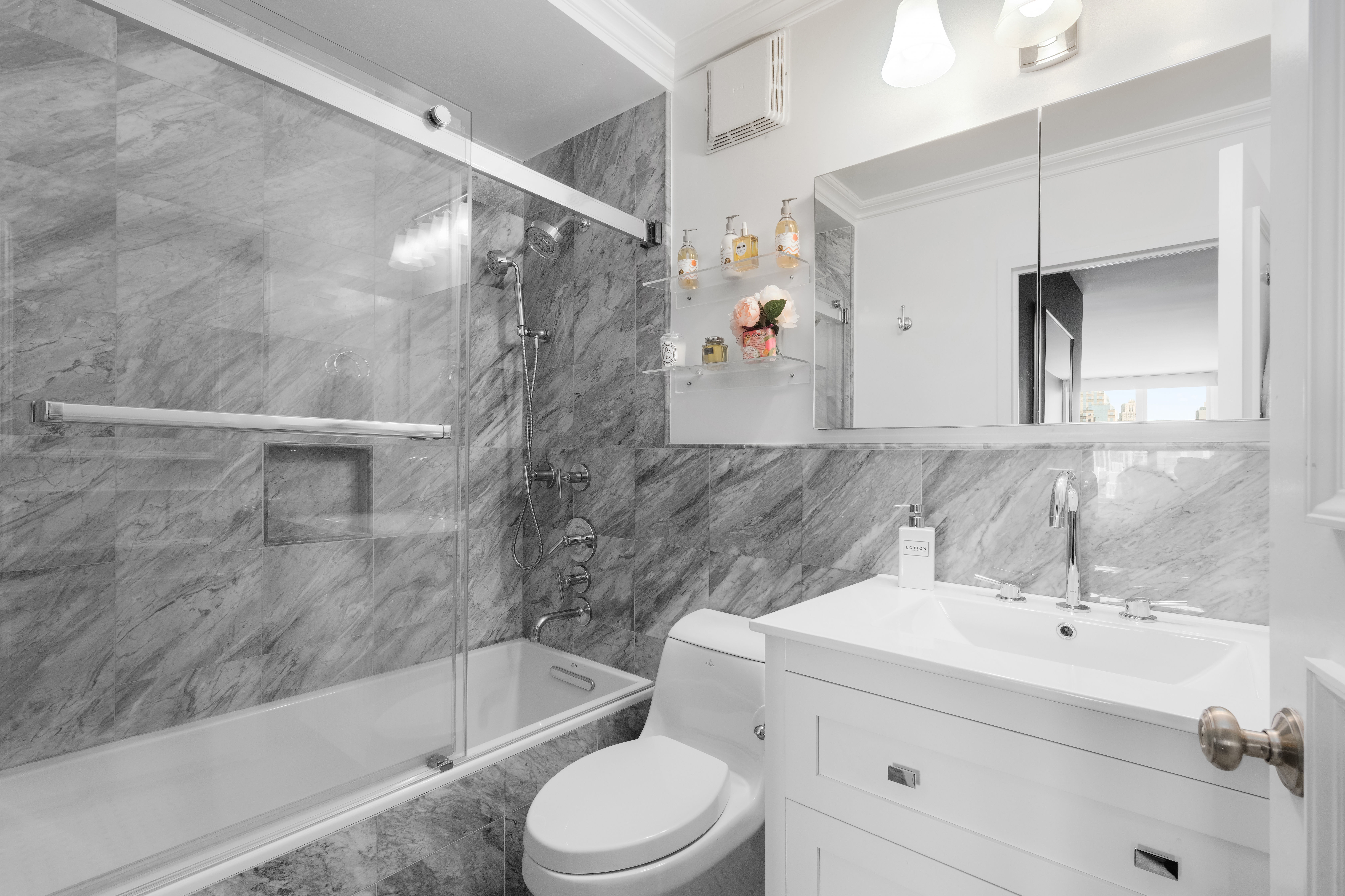 137 East 36th Street, Unit 21F Manhattan, NY 10016 - Photo 13 of 20 a bathroom with a sink toilet and shower