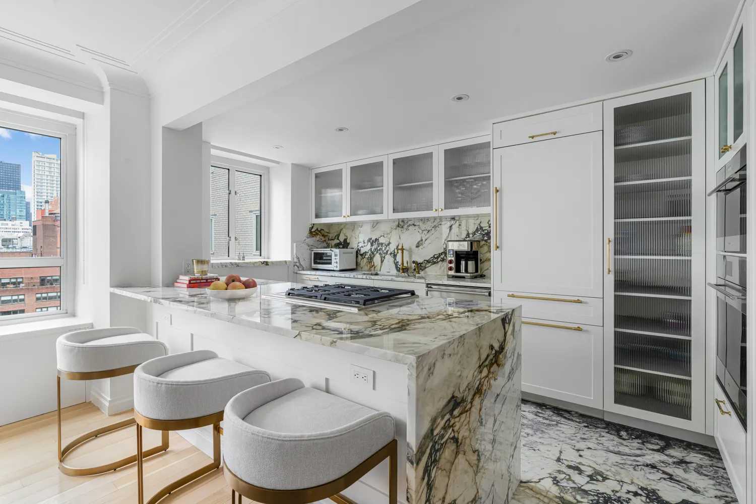 a kitchen with kitchen island granite countertop a table and chairs in it