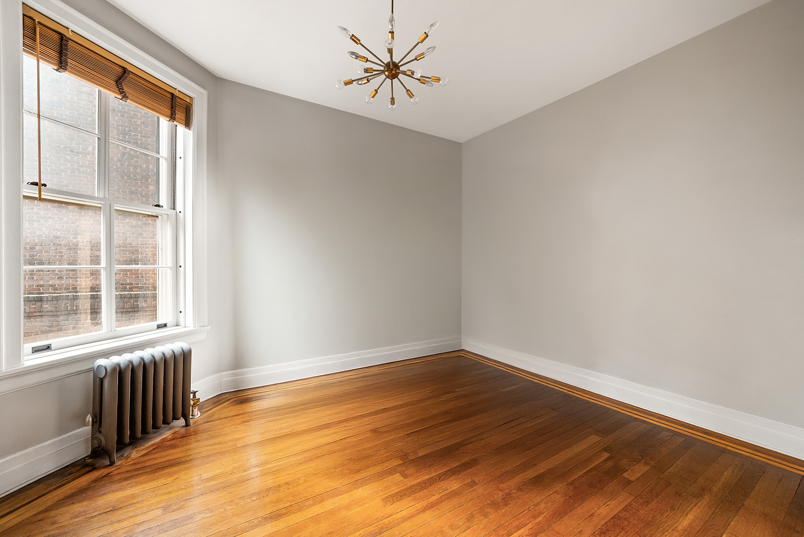 34-13 80th Street, Unit 31 Queens, NY 11372 - Photo 11 of 16 a view of an empty room with a window and wooden floor
