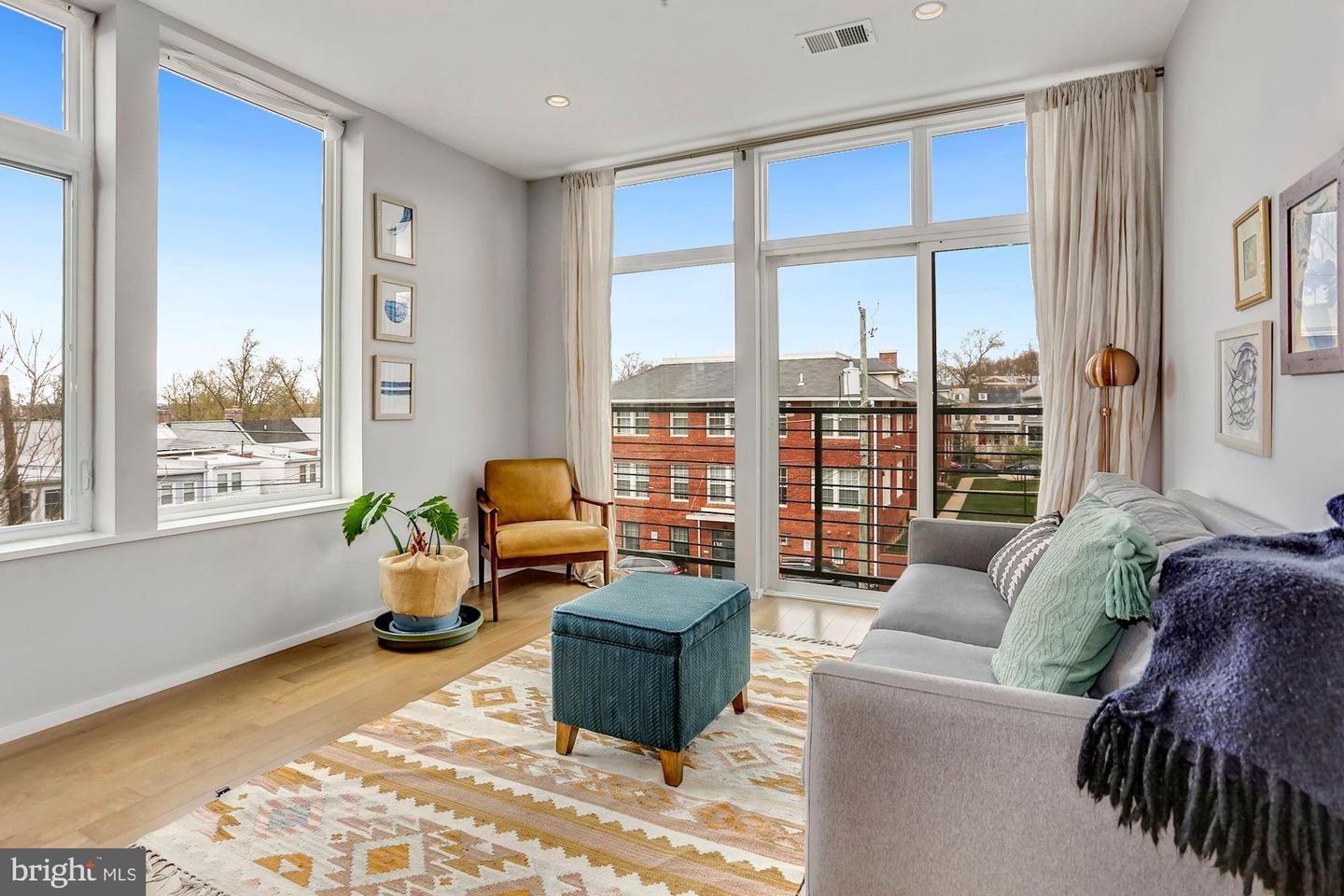 129 Varnum Street Northwest, Unit 6 Washington, DC 20011 - Photo 12 of 25 a living room with furniture and large windows