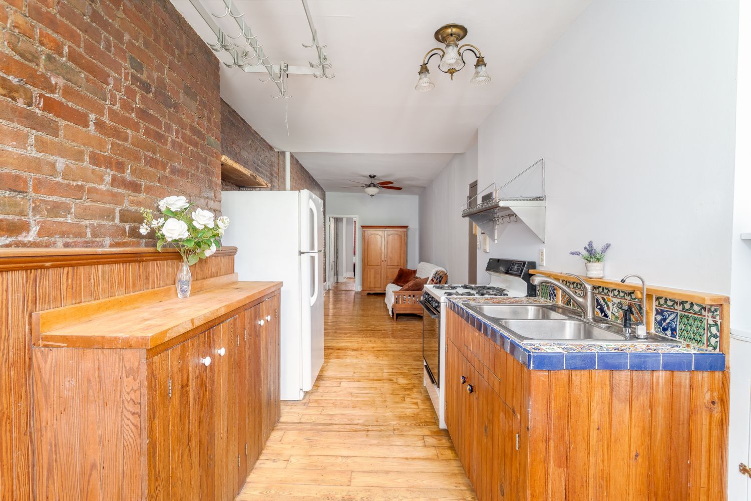 a kitchen with sink stove and cabinets