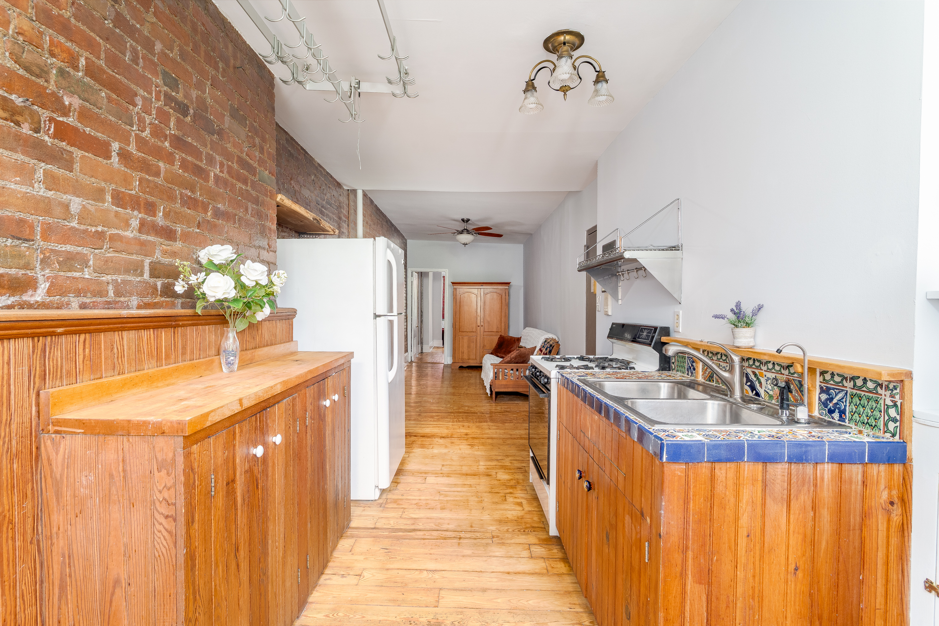 616 East 9th Street, Unit 4W Manhattan, NY 10009 - Photo 6 of 20 a kitchen with sink stove and cabinets
