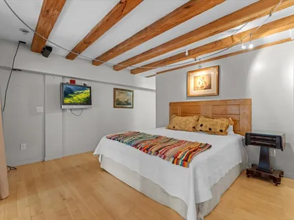 a bedroom with a bed and a tv