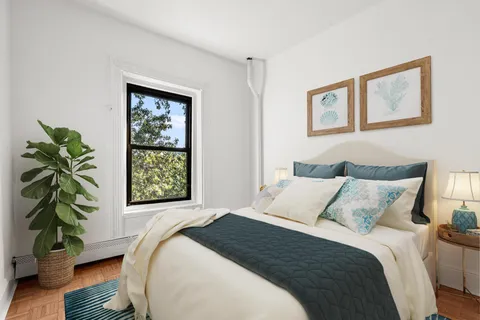 a bedroom with bed and a window