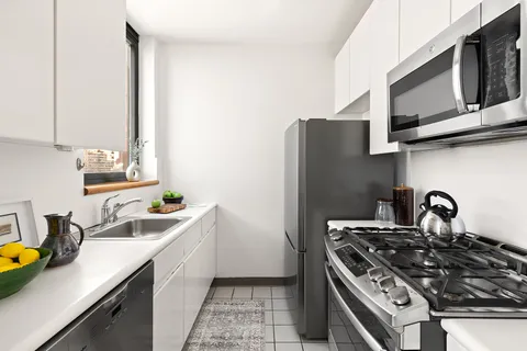 a kitchen with stainless steel appliances a stove a sink and a microwave
