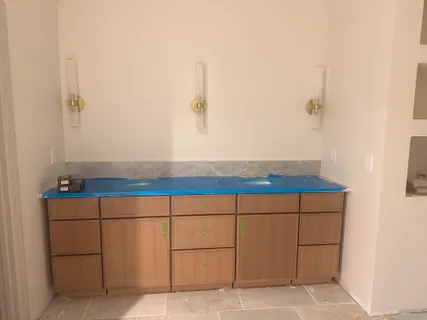 a bathroom with a sink and cabinets