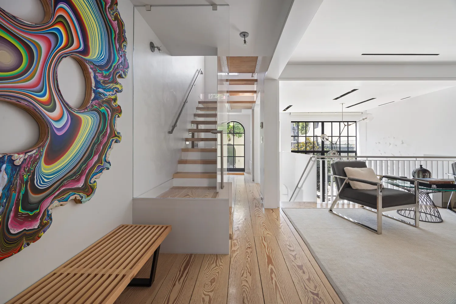 a view of entryway with furniture and wooden floor