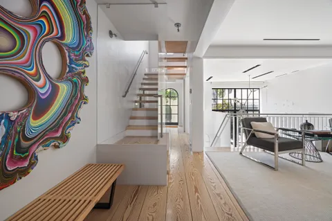a view of entryway with furniture and wooden floor