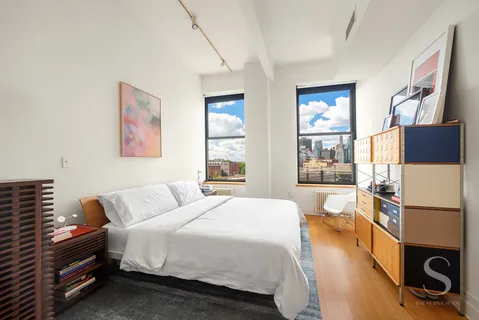 a bedroom with a bed and a window