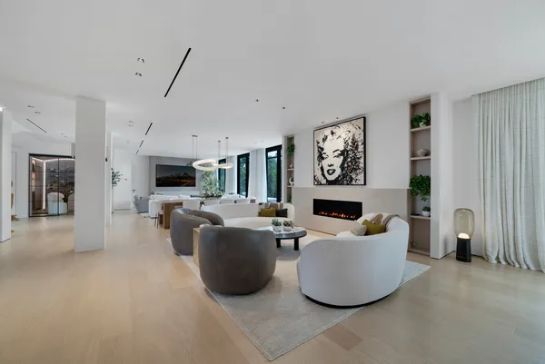 a living room with furniture and large windows