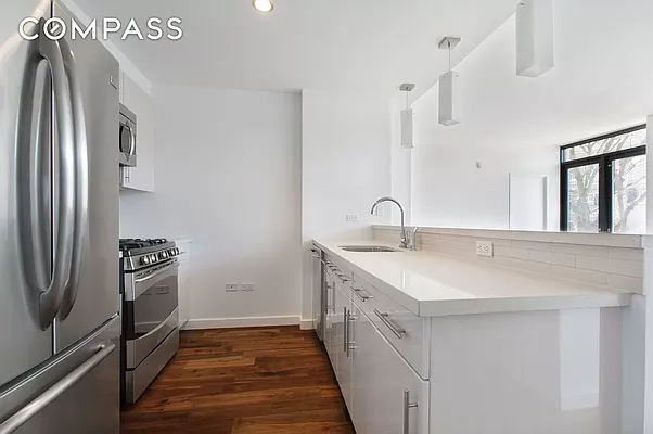 125 North 5th Street, Unit 2E Brooklyn, NY 11249 - Photo 2 of 11 a kitchen with a sink and stainless steel appliances