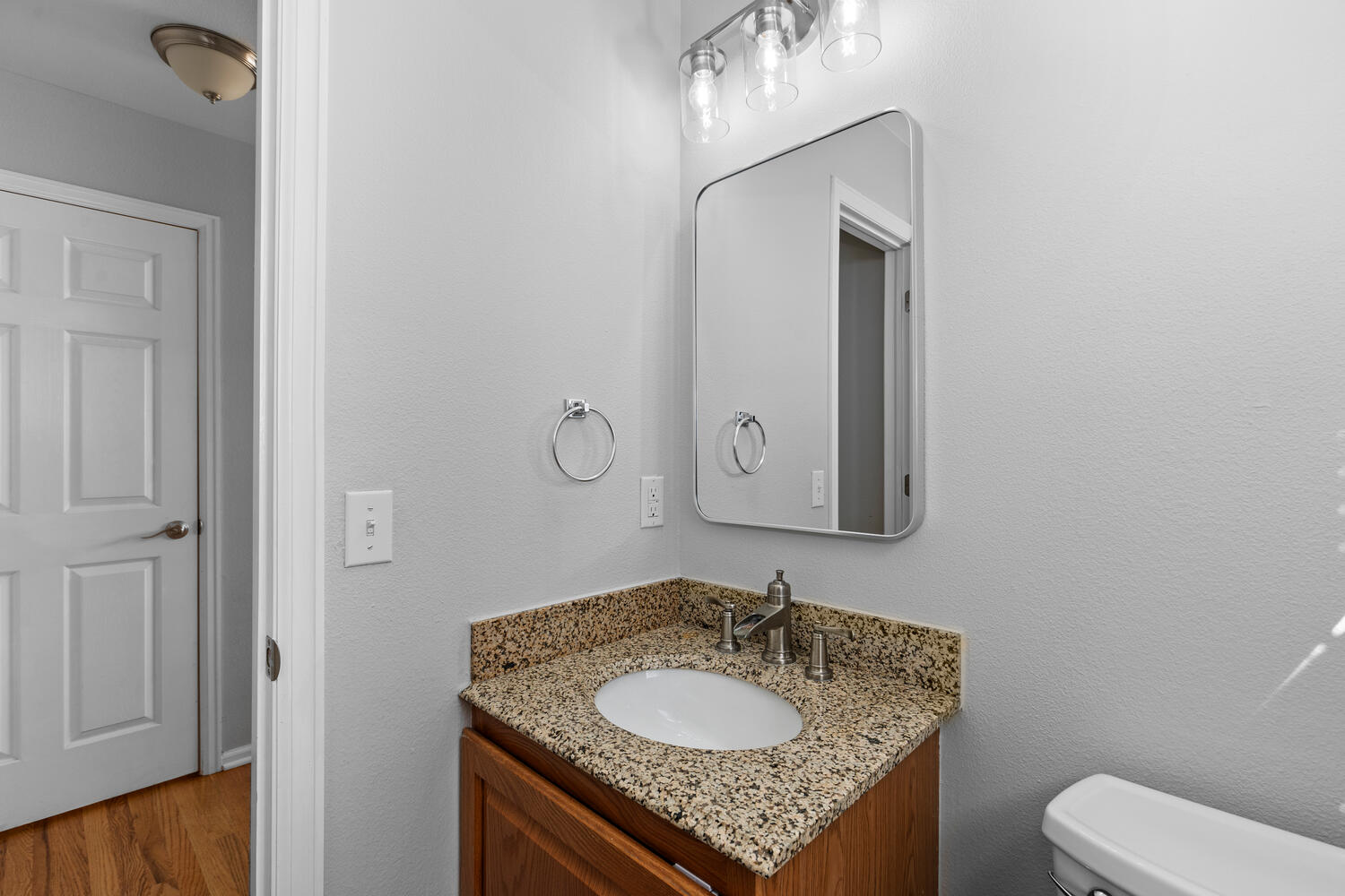 847 Timbervale Trail Highlands Ranch, CO 80129 - Photo 19 of 36 a bathroom with a granite countertop sink toilet and mirror