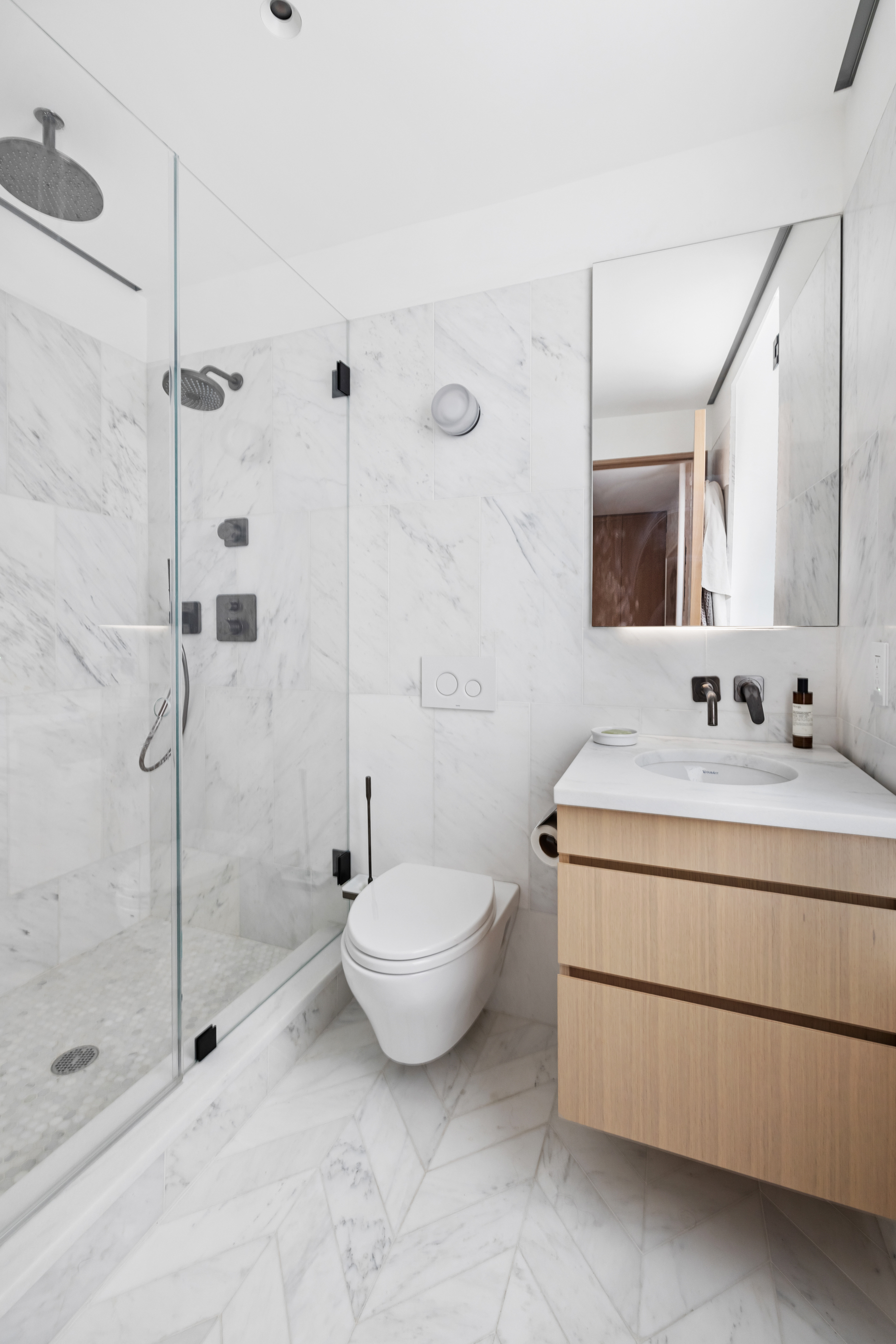 57 Thompson Street, Unit 4E Manhattan, NY 10012 - Photo 13 of 16 a bathroom with a sink toilet and shower