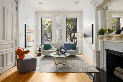 a living room with furniture fireplace and window