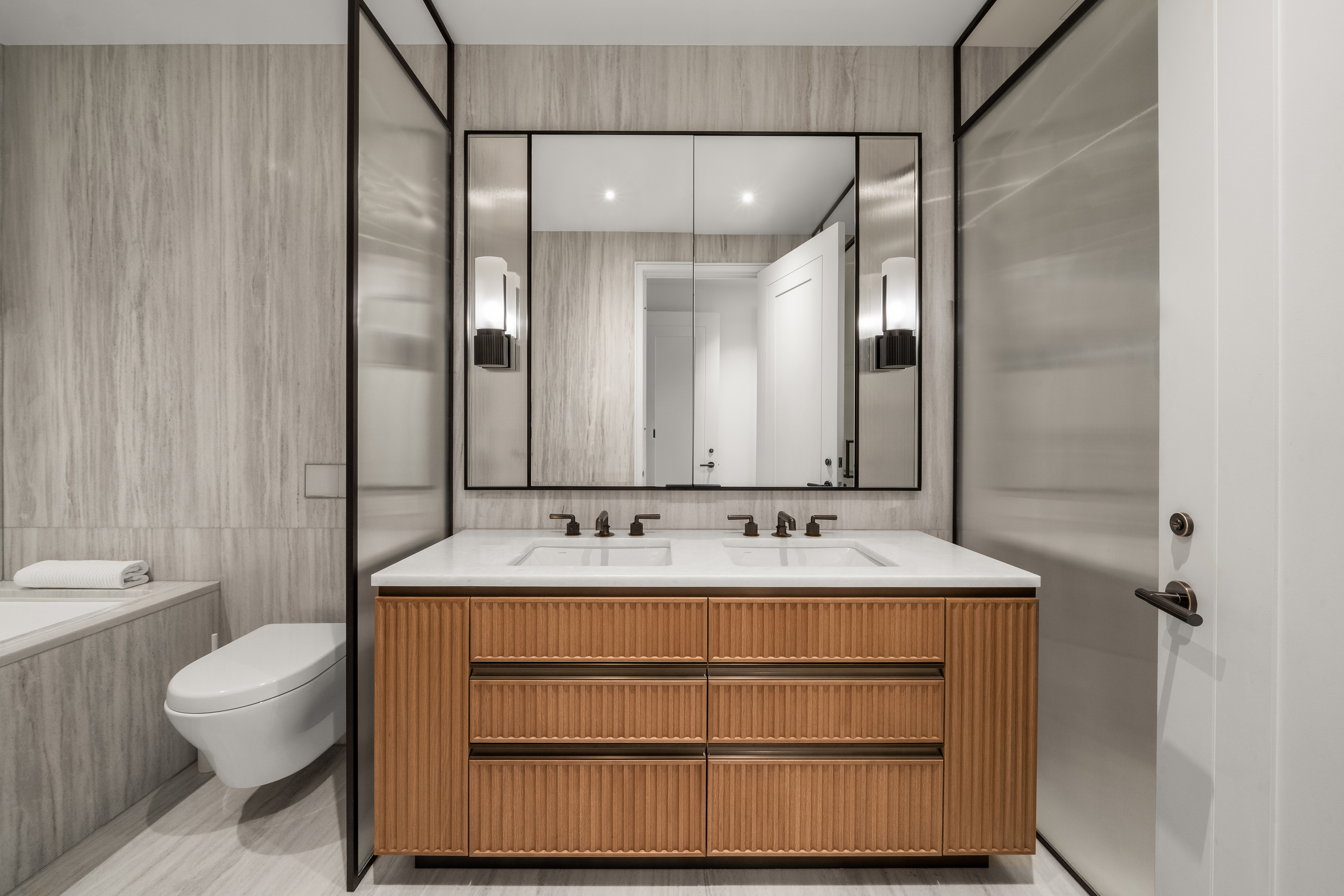 515 West 18th Street, Unit 210 Manhattan, NY 10011 - Photo 5 of 14 a bathroom with a sink toilet double vanity and shower