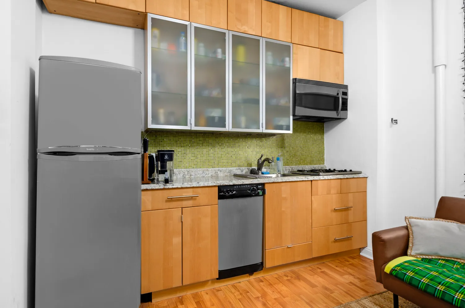 a kitchen with stainless steel appliances granite countertop a refrigerator and a sink